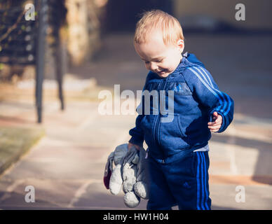 Little boy with teddy bear enjoying the sunshine Stock Photo