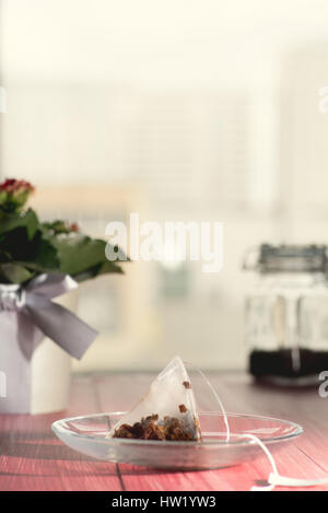 Used tea bag on the glass plate. Copy space. Stock Photo