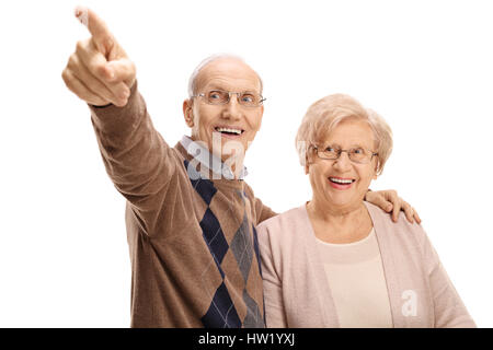 Mature man showing something in the distance to a mature woman isolated on white background Stock Photo