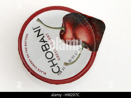 Top view of a container of cherry Chobani Greek yogurt against white background. Stock Photo