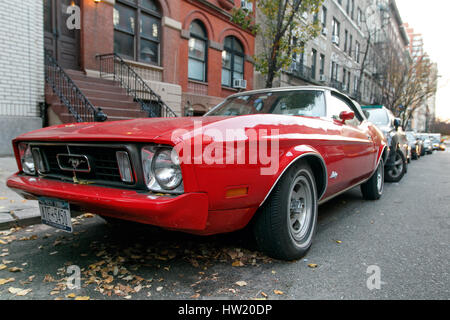 New York, November 28, 2016: A classic red Ford Mustang is parked in the street in Manhattan. Stock Photo