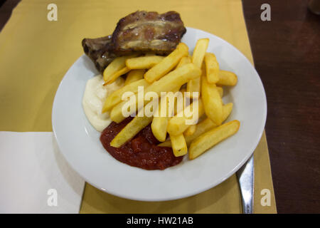 on a white plate lunch consisting of potatoes with meat Stock Photo