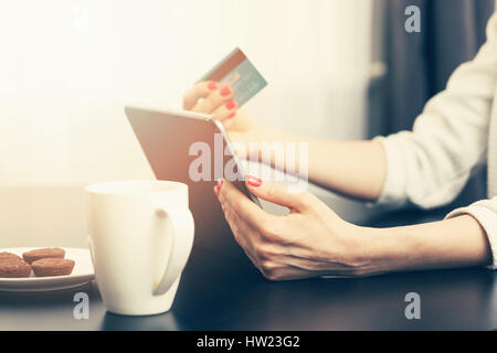 woman using digital tablet to make a payment with credit card Stock Photo