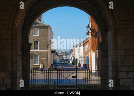 Bury St Edmunds Suffolk, a view west through the arch of the Norman tower looking towards the medieval and Georgian architecture in Churchgate Street. Stock Photo