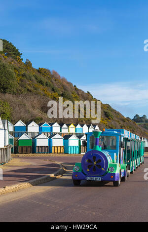 Bournemouth - Landtrain traveling along the promenade at Middle Chine, Bournemouth with beach huts in February Stock Photo