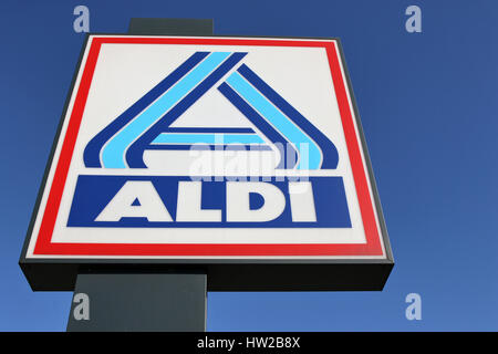 Aldi sign (north division) against blue sky. Aldi is a leading global discount supermarket chain with almost 10,000 stores in 18 countries. Stock Photo