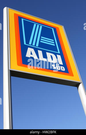 Aldi sign (south division) against blue sky. Aldi is a leading global discount supermarket chain with almost 10,000 stores in 18 countries. Stock Photo