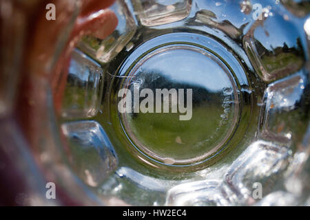 A view looking through an empty drinking glass on a summer day. Stock Photo