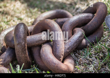 big rusty chain laying on floor Stock Photo