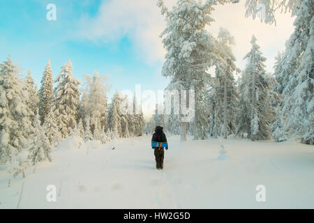 Caucasian man standing in snowy forest