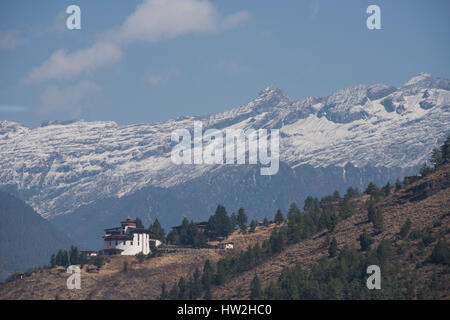 Bhutan, Paro, capital of Paro District aka Dzongkhag. Ancient watchtower, Ta Dzong, home to the National Museum of Bhutan with snow-capped mountaind i Stock Photo