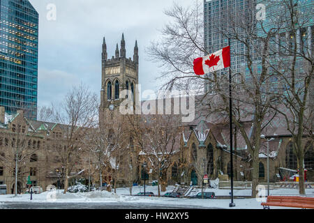 St. George's Anglican Church at Canada Square with flag - Montreal, Quebec, Canada Stock Photo