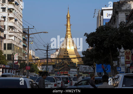 Sule pagoda towers over the traffic on Maha Bandoola Road in downtown Yangon, Yangon Region, Myanmar Stock Photo