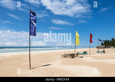 Colourful flags on the white sand beach at Kabalana, Ahangama, Sri Lanka Stock Photo