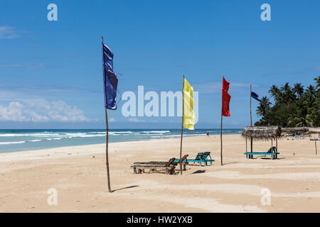 Colourful flags on the white sand beach at Kabalana, Ahangama, Sri Lanka Stock Photo