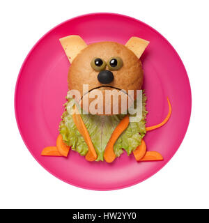 Sad cat made of bread, cheese and vegetables on pink plate Stock Photo