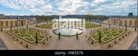 Symmetric french gardens of the Orangerie of Versailles palace in France, panoramic view. Stock Photo