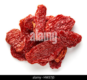 Heap of sun dried tomatoes isolated on wooden background, top view Stock Photo