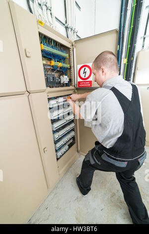 electrician tightened fuses in the electrical switchboard Stock Photo