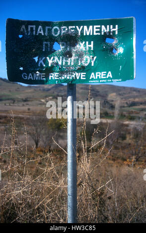 Cyprus. Hunters shoot 'Game Reserve Area sign'       full of holes. Songbirds beware! Stock Photo