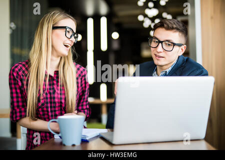 Cheerful business team working on computer in office Stock Photo