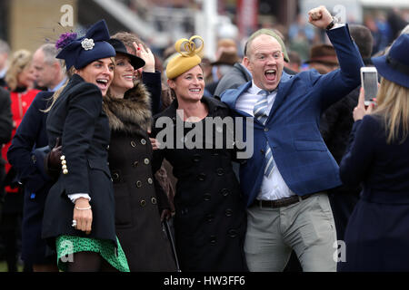 Zara Tindall (second Left), Dolly Maude and Mike Tindall pose for a photo during St Patrick's Thursday of the 2017 Cheltenham Festival at Cheltenham Racecourse. Stock Photo