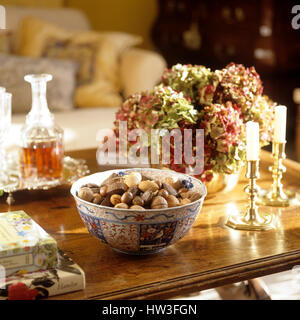 Bowl of nuts on coffee table. Stock Photo