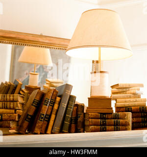 Lamp on top of old books. Stock Photo