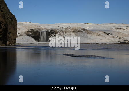 Iceland, Skogar, Skogafoss, Skogafoss waterfall surrounded by snow and ice in winter Stock Photo