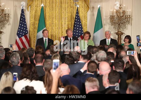 US President Donald Trump (centre) speaks as he stands with Irish Taoiseach Enda Kenny (left) and his wife Fionnuala Kenny (third right) and Mike Pence (right), during the St. Patrick&Otilde;s Day Reception and Shamrock Presentation Ceremony, in the White House, Washington DC, USA. Stock Photo