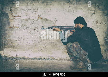 terrorist in black uniform and mask with kalashnikov ak47 Stock Photo