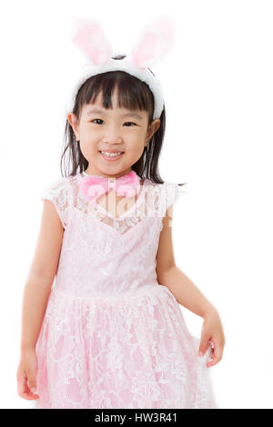 Chinese Little Girl in banny costume on plain white isolated background. Stock Photo