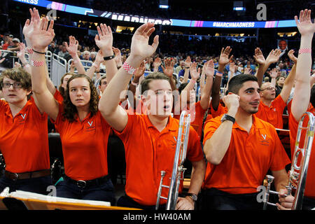 City, Florida, USA. 16th Mar, 2017. OCTAVIO JONES | Times .University of Virginia Pep Band members Jessica Fairly, 21, left, Josh Cockream, 21, and Jonathan Palmer cheer on their school while playing against the University of North Carolina at Wilmington during the NCAA Men's Basketball Tournament in Orlando on March 16, 2017. Cockream is a Tampa native and graduate of Strawberry Crest High School. Credit: Octavio Jones/Tampa Bay Times/ZUMA Wire/Alamy Live News Stock Photo