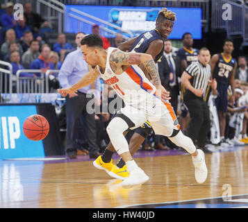 Florida guard Chris Chiozza (11) shoots a three-point shot during the ...