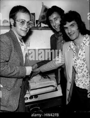 Mar. 03, 1974 - ELTON JOHN - BIRTHDAY BOY: Celebrating his 27th birthday at the Room at the Top, Ilford, Essex pop star Elton John joined in the fun with footballers Martin Chivers, Tottenham Hotspurs and Ian Morgan, Watford. Elton John, a director of Watford Town Football Club entertained more than 1,000 guests at the Testimonial evening for Morgan who transferred from Queen's Park Rangers to Watford. Photo shows. Elton John cuts his birthday cake with the help of fotballers Martin Chivers and Ian Morgan, at the testimonial evening for Morgan at the Room at the Top, Ilford. (Credit Image: © K Stock Photo