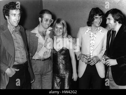 Mar. 03, 1974 - Elton John - Birthday Boy. Celebration his 27th birthday at the Room at the Top, Ilford, Essex pop star Elton John joined in the fun with footballers Martin Chivers, Tottenham Hotspurs and Ian Morgan, Watford. Elton John, a director of Watford Town Football Club entertained more than 1,000 guests at the Testimonial evening for Morgan who transferred from Queen's Park Rangers to Watford. L to R: Footballer Martin Chivevs, Elton John, Ian Morgan. (Credit Image: © Keystone Press Agency/Keystone USA via ZUMAPRESS.com) Stock Photo