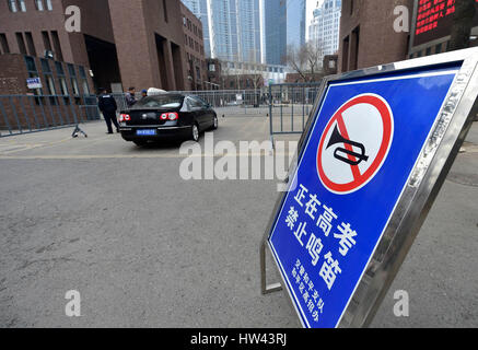 Tianjin, China. 17th Mar, 2017. A warning board reading 'exam ongoing, no whistle' is set outside the Tianjin Yaohua Middle School in Tianjin, north China, March 17, 2017. Students took part in the first test for English as part of China's National College Entrance Examination in Tianjin on Friday. As from 2017, two oral and written tests will be held for English during the National College Entrance Examination in Tianjin, and the better scores will be chosen as the final results. Credit: Yue Yuewei/Xinhua/Alamy Live News Stock Photo