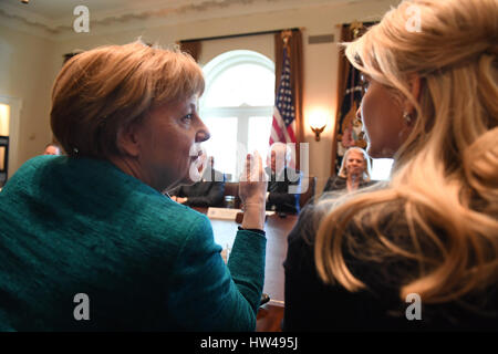 Washington, USA. 17th Mar, 2017. German Chancellor Angela Merkel (L) speaks with Ivanka Trump during a roundtable discussion on vocational training with United States and German business leaders in the Cabinet Room of the White House in Washington, DC on March 17, 2017. Credit: MediaPunch Inc/Alamy Live News Stock Photo