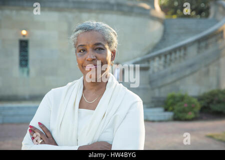 Portrait of Black woman posing near stone staircase