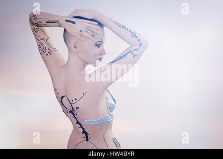Tattoos on arms and back of futuristic woman Stock Photo
