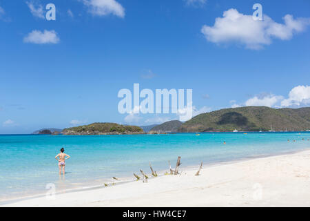 Caucasian woman standing in ocean on tropical beach Stock Photo