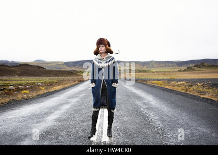 Caucasian woman standing in middle of road Stock Photo