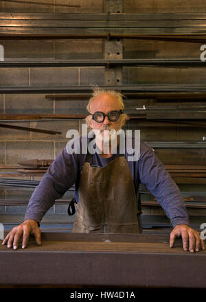Portrait of serious Caucasian blacksmith in workshop Stock Photo