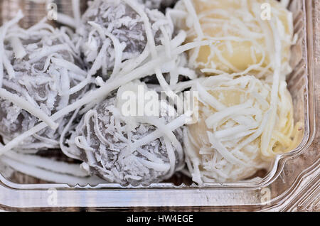 Thai tradition dessert with banana stuff and coconut slices topping Stock Photo