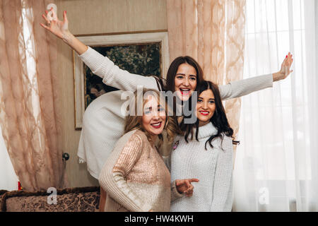 three beautiful sisters posing for the camera and smiling Stock Photo