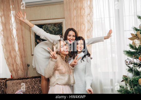 three beautiful sisters posing for the camera and smiling Stock Photo