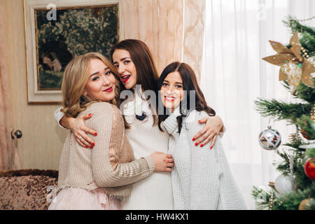 three beautiful sisters posing for the camera and smiling Stock Photo