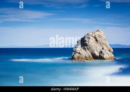 Rock in a blue sea. Sansone beach. Elba island. Tuscany, Italy. Long exposure photography Stock Photo