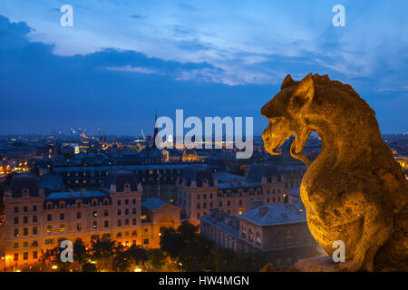 PARIS - JULY 15,2014: Gargoyle on the roof of Notre Dame, Paris Cathedral. Night view from the roof top of Notre Dame de Pari. July 15,Paris, France. Stock Photo