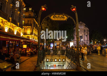 PARIS - JULY 12, 2014: Art Noveau Metropolitan sign in Place St. Michel. Saint Michel station located in the center of Paris, near Notre Dame Cathedra Stock Photo